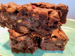 A dark fudge brownie with marshmallows, pretzels and candy