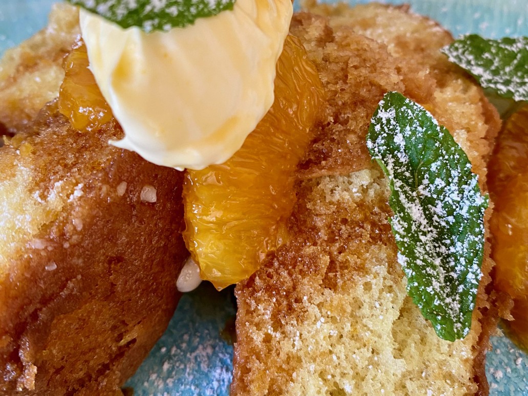 An orange sponge cake with caramelised oranges and cream