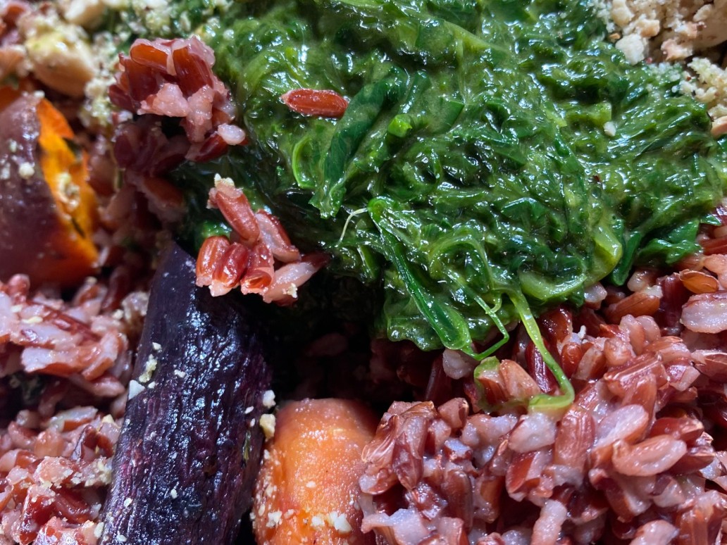 A colourful warm red rice salad with wild garlic, carrots and hazelnuts