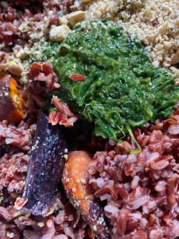 A colourful warm red rice salad with wild garlic, carrots and hazelnuts