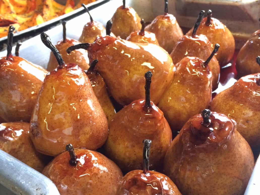 Pears in a roasting tin covered in red wine caramel sauce
